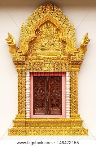 The Thai style golden carving wooden window.