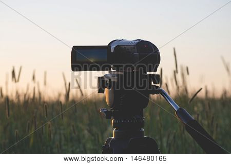Video camera on a tripod at sunset