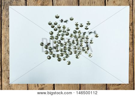 Clear paper and nail on wood table