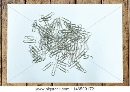 Clear paper and paper clip on wood table