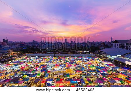 Aerial view night market roof top with dramatic sky and city downtown background