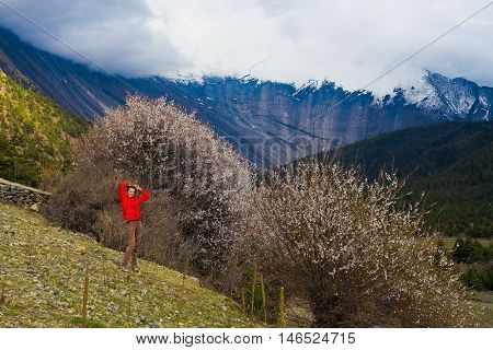 Portrait Young Pretty Girl Wearing Red Jacket Himalays Mountains.Asia Nature Morning Volcano Viewpoint.Mountain Trekking, View Landscape.Woman Happy Smiling.Horizontal picture. Hikking Sport Activity