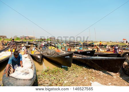 Heho Myanmar - March 02 2011 - Burmese people trading at an floating market. Boats are full of gasoline and other goods