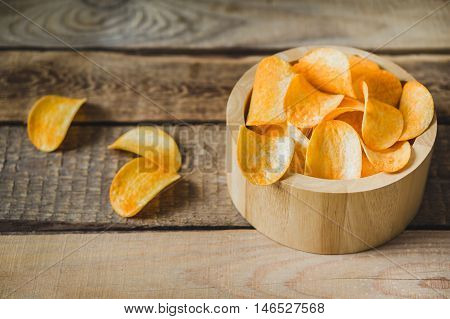 chips in a wooden bowl on the table