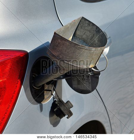 pouring fuel into the car gas tank