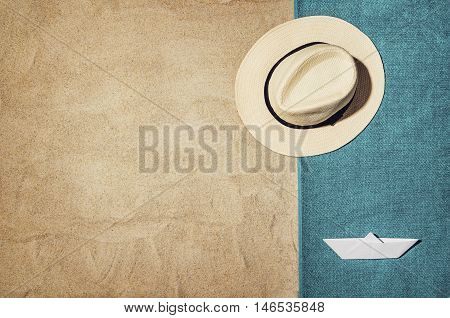 Top view of sandy beach with summer accessories and copy space around products. Blank mock up for advertising or packaging.