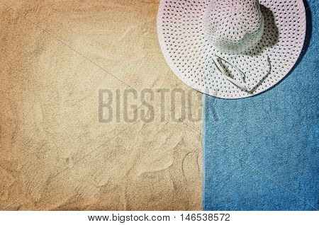 Top view of sandy beach with summer accessories and copy space around products. Blank mock up for advertising or packaging.