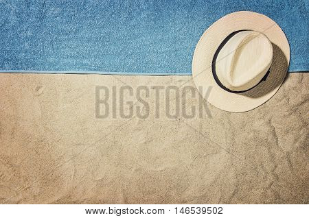 Top view of sandy beach with summer accessories and copy space around products. Blank mock up for advertising or packaging.