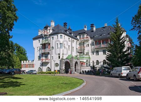 IMATRA, FINLAND - JULY 2, 2016: People near Hotel Rantasipi Imatran Valtionhotelli. Was built in 1903 and designed by the Art Nouveau castle.
