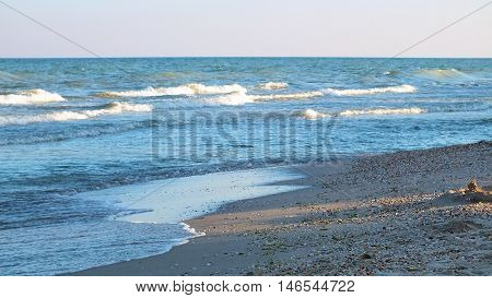 Photo sandy beach, washed by the sea wave. Photo taken on the coast of the Azov Sea in August 2016.