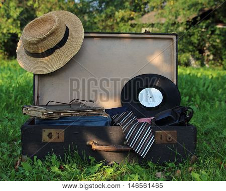 suitcase old opened on a grass in a garden