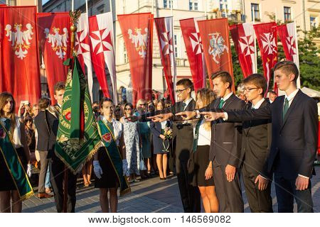 KRAKOW, POLAND - FEB 10, 2016: Unidentified participants of ceremony is the vow of first classes of the Jan III Sobieski High School (founded in 1883) at the Main Market Square near St.Mary Cathedral.