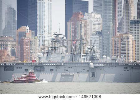 JERSEY CITY NJ - MAY 31 2016: USS Bataan (LHD 5) on the Hudson River passes Lower Manhattan upon departing Manhattan marking the end of Fleet Week 2016 as seen from Liberty State Park.