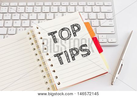 Word text Top tips on white paper on office table / business concept