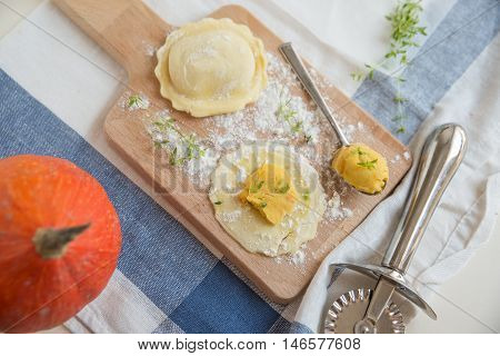 homemade stuffed with pumpkin ravioli on a wooden board