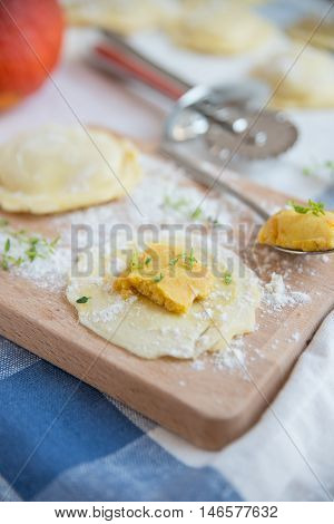homemade stuffed with pumpkin ravioli on a wooden board