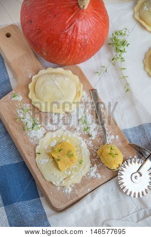 homemade stuffed with pumpkin ravioli on a wooden board