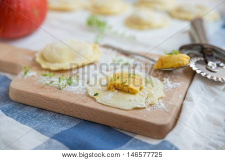 homemade stuffed with pumpkin ravioli on a wooden board
