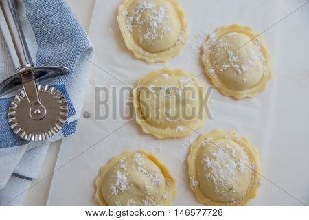 homemade stuffed with pumpkin ravioli on a wooden board