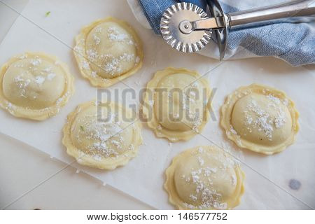 homemade stuffed with pumpkin ravioli on a wooden board