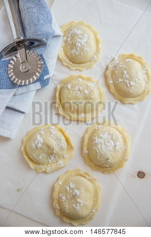 homemade stuffed with pumpkin ravioli on a wooden board