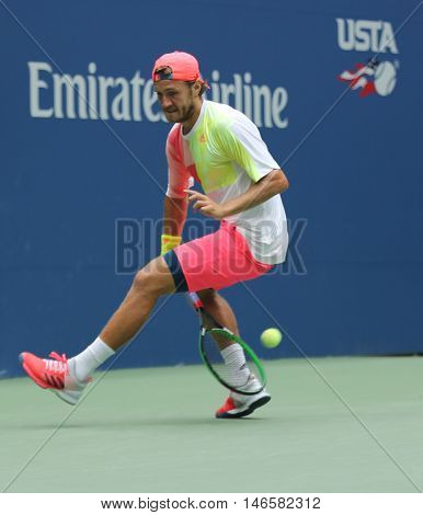 NEW YORK - SEPTEMBER 6, 2016: Professional tennis player Lukas Poulle of France using Tweener during round four match at US Open 2016 at Billie Jean King National Tennis Center