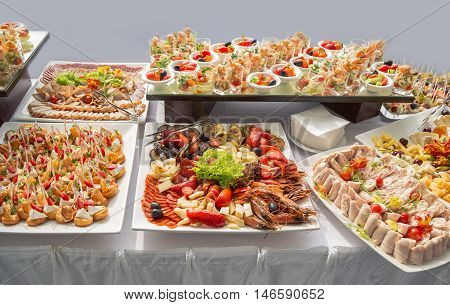 Banquet Table in restaurant served with different meals. Ready for wedding reception.