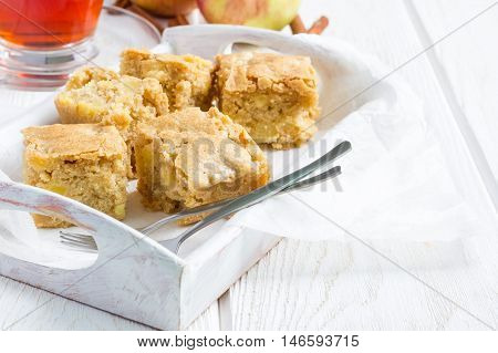 Homemade blondie (blonde) brownies apple cake square slices in wooden tray horizontal copy space