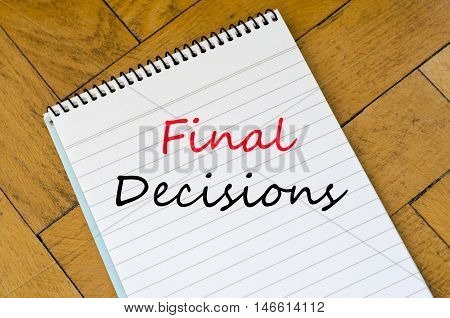 White notepad on the wooden background .