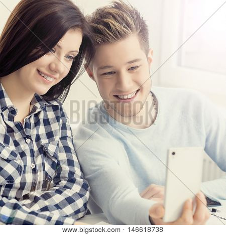 Boy and girl taking selfie on a lesson at chool.