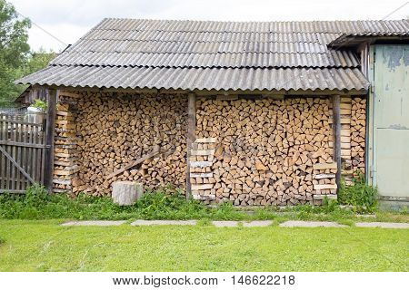 Woodpile near house in a Russian village