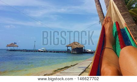 unidentified girl relaxing in a hammock overlooking the Caribbean.