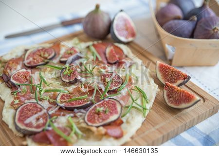 freshly baked French Flammkuchen with figs and cheese