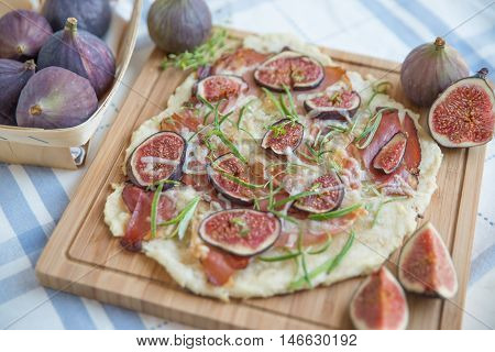 freshly baked French Flammkuchen with figs and cheese