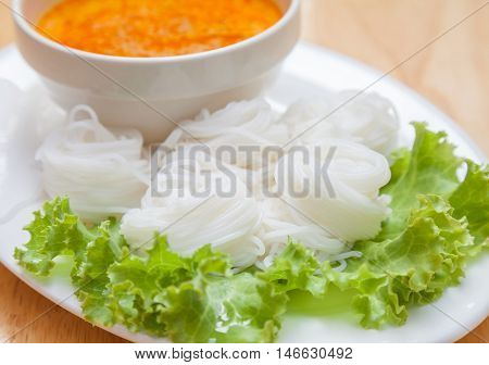 Rice noodles in fish curry sauce with vegetables is Thai food.