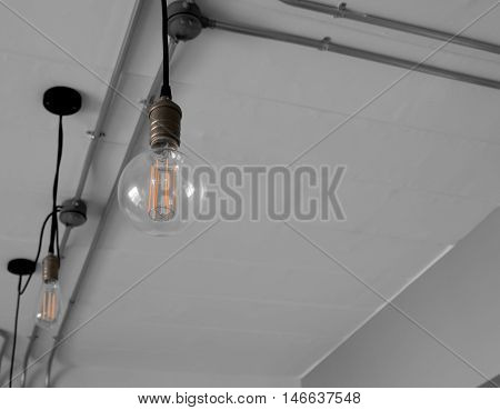 Edison's light bulb and lamp in modern style. Warm tone light bulb lamp. Lamps in coffee shop.