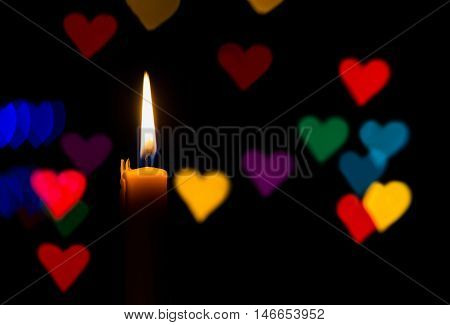 Many heart shape colors and candle on the dark background