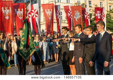 KRAKOW, POLAND - FEB 10, 2016: Unidentified participants of ceremony is the vow of first classes of the Jan III Sobieski High School (founded in 1883) at the Main Market Square near St.Mary Cathedral.