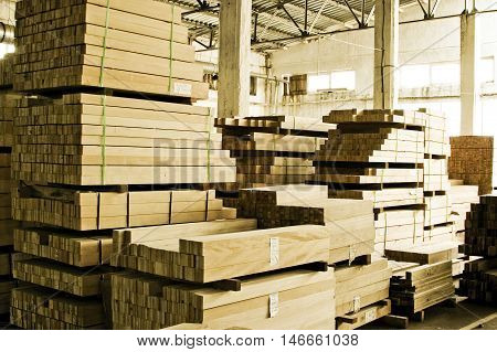 Stacks of lumber for construction in warehouse.