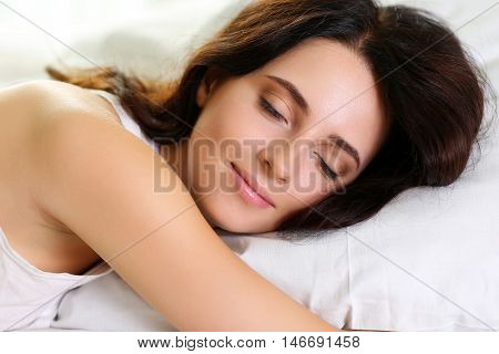 Young Beautiful Brunette Woman Portrait Lying In Bed