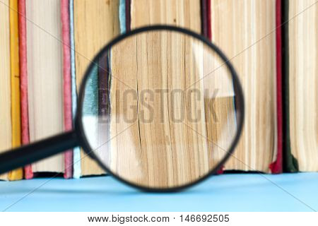 composition with book and magnifying glass. Back to school copy space. Education background.