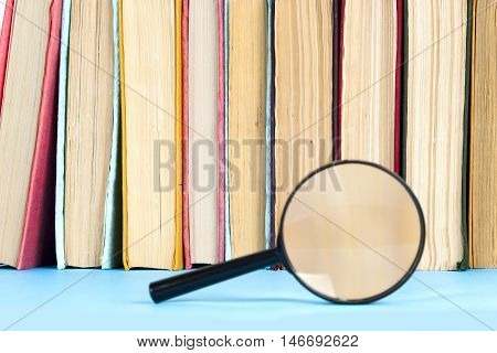 composition with book and magnifying glass. Back to school copy space. Education background.