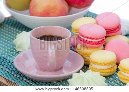 Still life of served coffee cups macaroon cookies marshmallows and apples