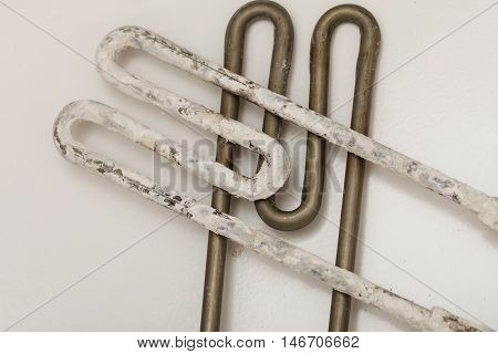 Mechanical technology industry concept. Comparision of two heaters. New washing machine part and old covered in sediment.