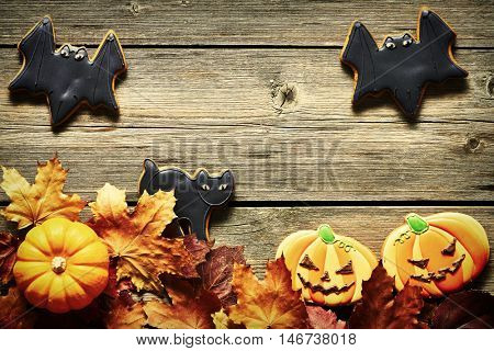 Halloween homemade gingerbread cookies over wooden background