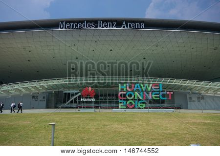 SHANGHAI CHINA - SEPTEMBER 2 2016: Attendees of Huawei Connect 2016 information technology conference near entrance to Mercedes-Benz Arena in Shanghai China on September 2 2016.
