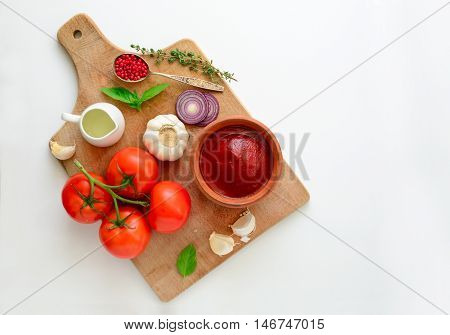 Ketchup or tomato sauce ingredients on a cooking board concept background blank space for a text