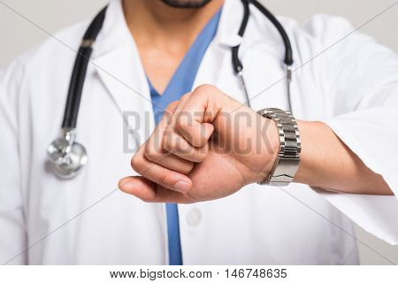 Doctor looking at his watch