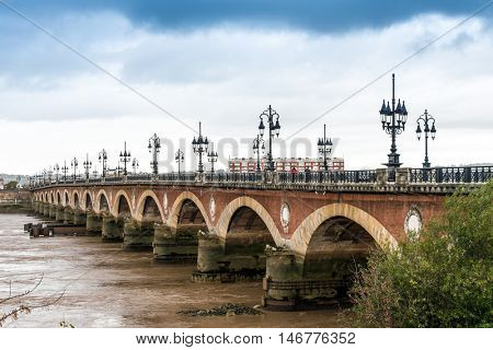 Old stony bridge in Bordeaux, France Europe