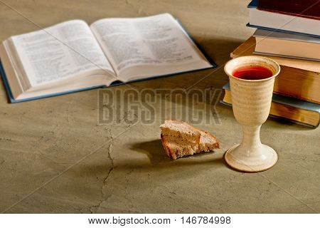 chalice of wine with bread and bible